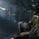A Bloodborne screenshot showing the Hunter player-character sitting against some sorta surface.